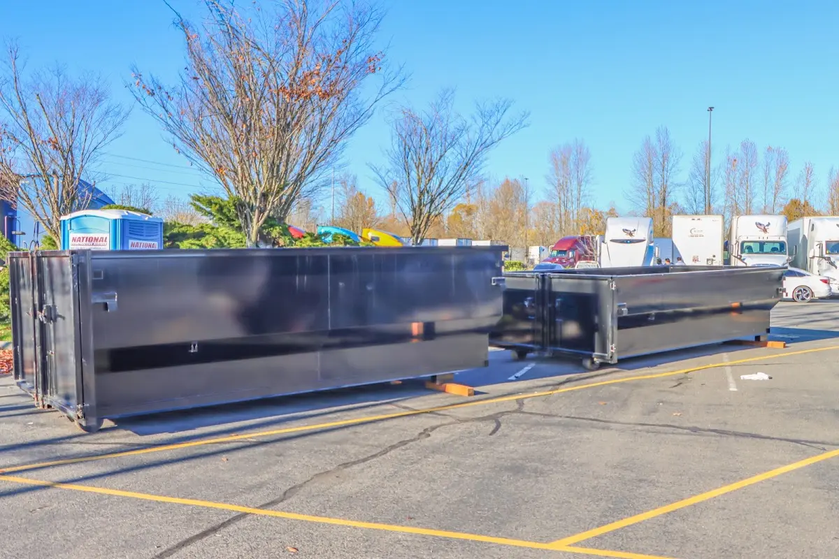 Professional dumpster rental service with roll-off container on residential driveway in Mount Arlington